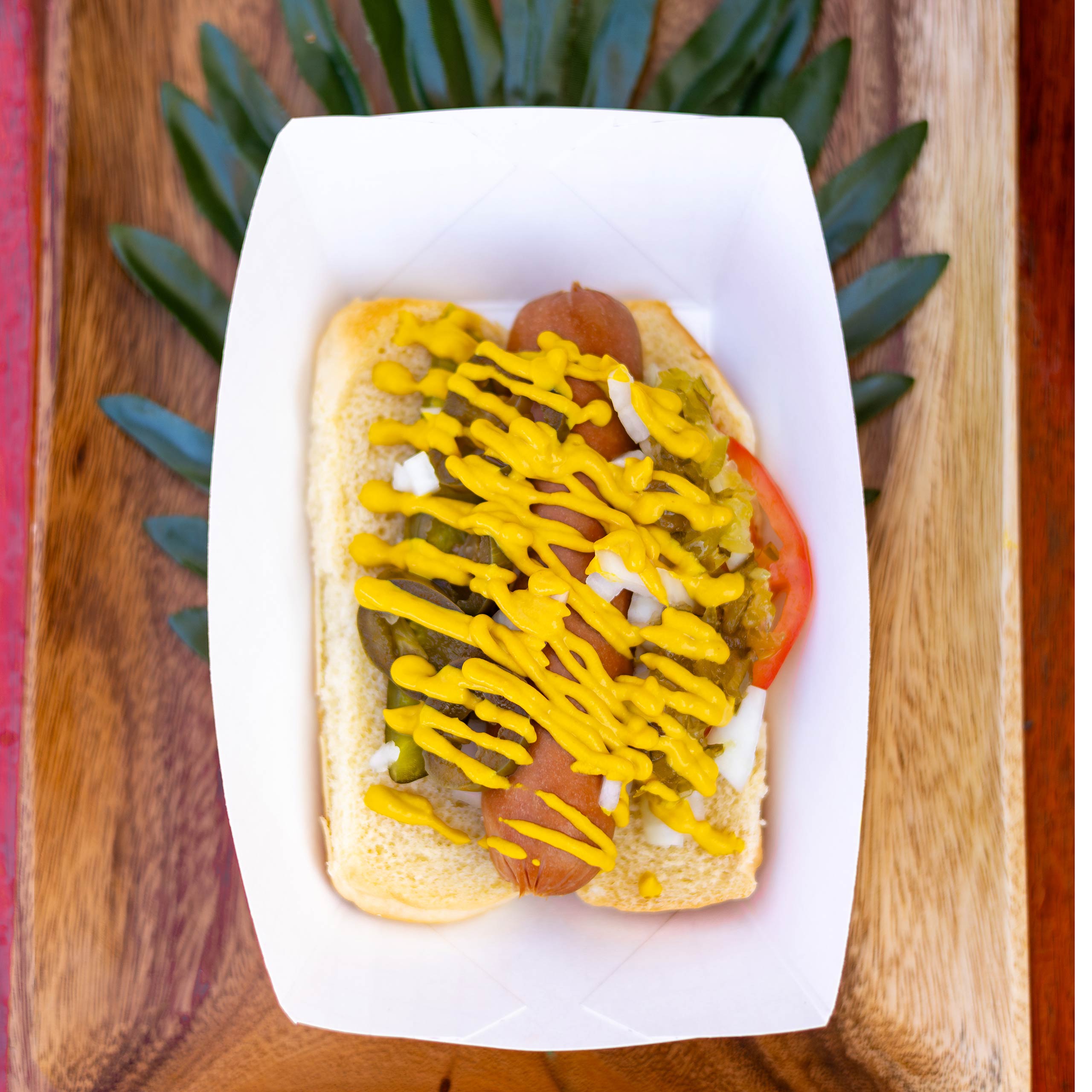 HotDog with pickle, tomato, jalapeno, onion, relish, and mustard.​