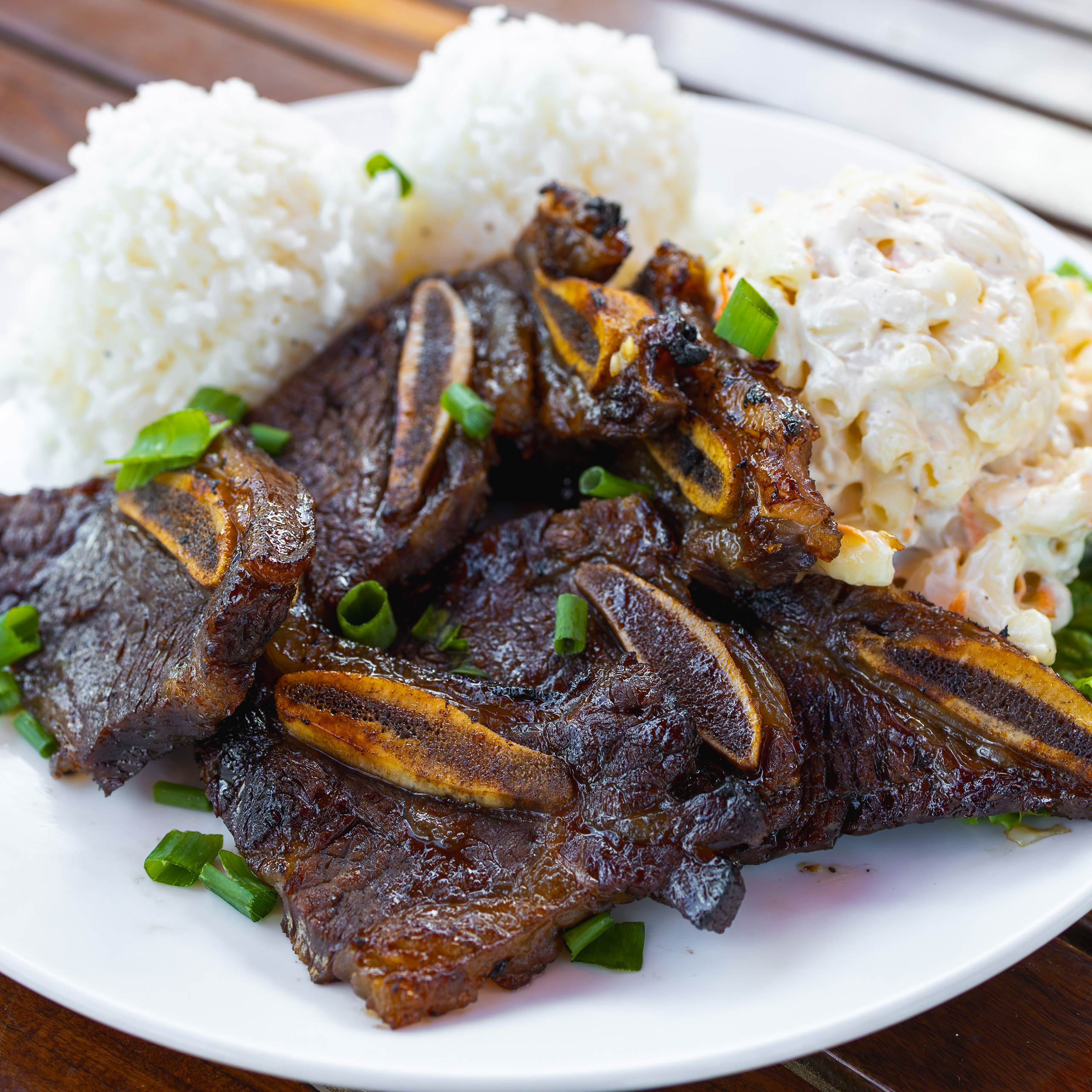 Beef short ribs, BBQ'd Polynesian style. Served with rice and macaroni salad.